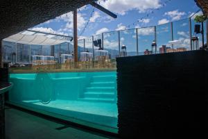 a swimming pool on the top of a building at The Charlee Hotel in Medellín