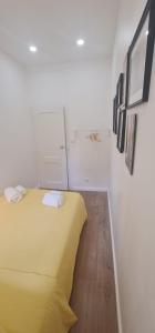 a bedroom with a yellow bed and a wooden floor at S.Soares Yellow Beato in Lisbon