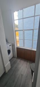 a bathroom with a washing machine and a window at S.Soares Yellow Beato in Lisbon