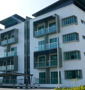 un edificio de apartamentos con balcones y luz de la calle en FAIZ HOMESTAY, en Kuching