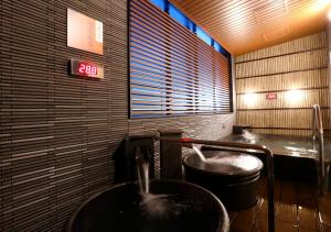 a bathroom with a sink and a trash can at APA Hotel Omori Ekimae in Tokyo
