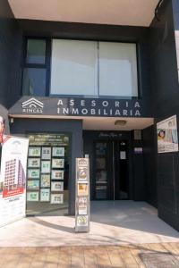 a building with a sign in front of it at Apartamentos Doctor Clara in Castellón de la Plana
