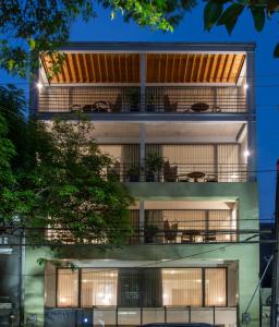 an apartment building with balconies at night at Colima 71 - Casa de Arte Hotel in Mexico City