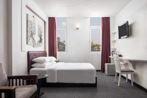 Postel nebo postele na pokoji v ubytování King Grand Boutique Hotel