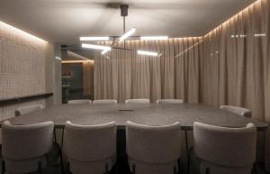 a conference room with a large table and chairs at Colima 71 - Casa de Arte Hotel in Mexico City