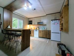 a kitchen with a counter and a white refrigerator at bungalov ve göl kenarina kurulmuş sahil evi. 