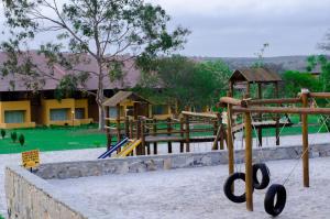 a park with a playground with a swing set at Flat Luxo em Gravatá Winterville in Gravatá