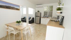 a kitchen and living room with a table and a refrigerator at Aura House Isla Verde in San Juan