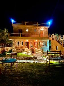 a house at night with a table in the yard at Bin Jbal Resort in Ouirgane