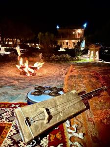 a gun sitting next to a fire pit at night at Bin Jbal Resort in Ouirgane