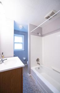 a bathroom with a tub and a sink and a bath tub at Cheerful home with free parking and WiFi in Rochester