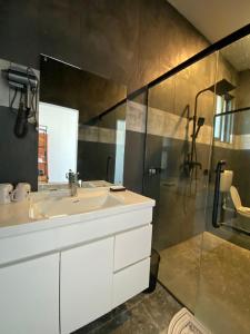 a bathroom with a white sink and a shower at coral coast FIJI in Sigatoka