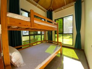 a bedroom with two bunk beds and a window at coral coast FIJI in Sigatoka