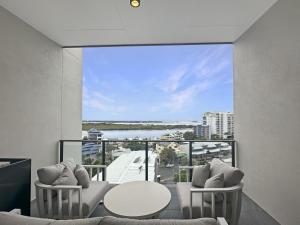 a living room with a view of the water at Direct Collective - Rhythm on Beach in Maroochydore