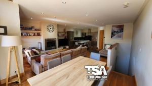 a living room with a couch and a table at Ice Chalet 2 in Thredbo