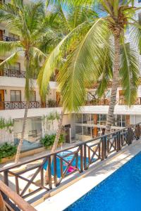 a view of a resort with palm trees and a pool at HOTEL KARAYA DIVE RESORT in Santa Marta
