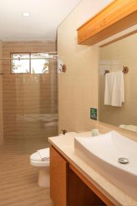 a bathroom with a sink and a toilet and a shower at HOTEL KARAYA DIVE RESORT in Santa Marta