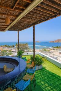 a patio with chairs and a pool and the beach at HOTEL KARAYA DIVE RESORT in Santa Marta