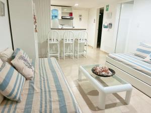 ein Wohnzimmer mit einem Sofa und einem Tisch in der Unterkunft Espectaculares Aptos Hansa Coral San Andres Islas in San Andrés