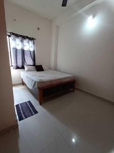 een slaapkamer met een bed en een raam bij SPOT ON 81072 The Golden Key in Rāipur