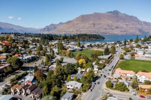 an aerial view of a small town with a lake and mountains at The Flaming Kiwi Backpackers in Queenstown