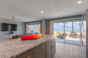 a kitchen with a large granite counter top with a view at Sea La Vie Beach Oceanfront Patio Pet Friendly in Jacksonville Beach