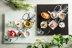 a table topped with dishes of food on plates at HAKODATE Uminokaze in Hakodate +46 photos
