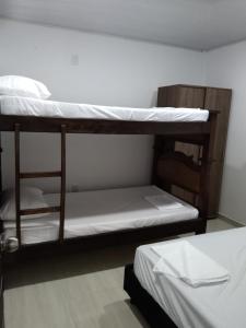 a couple of bunk beds in a room at Apartamento independiente en casa in Girardot
