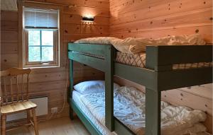 a bedroom with two bunk beds in a log cabin at Stunning Home In Lauvstad With Wifi And 2 Bedrooms in Lauvstad