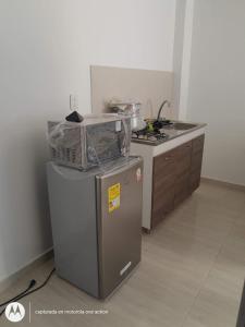 a kitchen with a refrigerator and a counter top at Apartamento independiente en casa in Girardot +6 photos