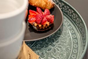 a plate with a cupcake with strawberries on it at Laura Five Senses in Florence