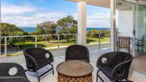 a porch with chairs and a table and a view of the ocean at Indulge In Ocean Views & Luxury! in Woorim +16 photos