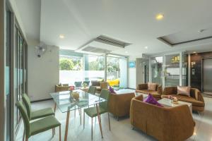 a living room with a glass table and chairs at G1 Touch Blue Sky in Kamala Beach