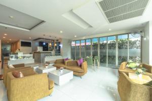 a large living room with couches and a kitchen at G1 Touch Blue Sky in Kamala Beach
