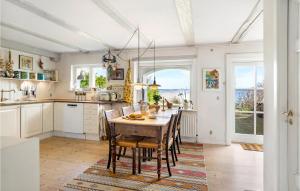 a kitchen with a table and chairs in a room at Beautiful Home In Hellebk With House Sea View in Hellebæk