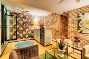 a living room with a couch and a table at Bata Merah Boutique Hotel in Banting