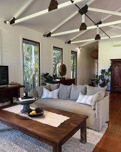 a living room with a couch and a coffee table at The Boathouses at Leaves & Fishes in Lovedale