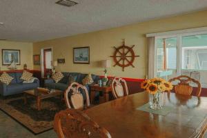 a living room with a wooden table and a couch at Admiral Suite in St. Augustine