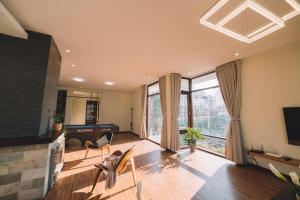 a living room with a fireplace and a television at Bliss House- Golfvalley Đà Lạt in Da Lat