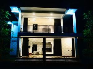 una casa con luci blu sulla parte anteriore di Forest Dew Udawalawa a Udawalawe