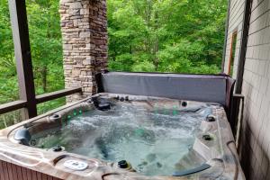 a jacuzzi tub in front of a window at Cardinal Perch in Beech Mountain