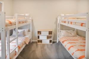 two bunk beds in a room with two beds at Autumn Home - Our Place at Bright in Bright