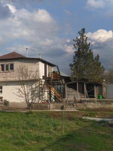 a house with a staircase in front of it at Уютный ночлег Иссыкские курганы in Rakhat