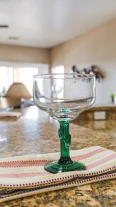 a glass wine glass sitting on top of a table at 120th Avondale home in Avondale