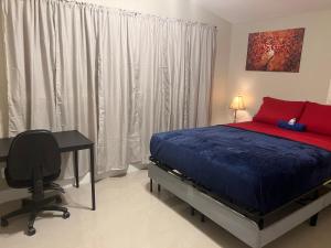 a bedroom with a bed and a desk and a bed sidx sidx sidx at Oak Ridge House in Tampa +1 photo