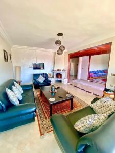 a living room with a couch and a table at ATGAL Ferme D'hote in Azrou