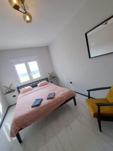 a bedroom with a large bed and a chair at Seaside Dream in Thessaloniki