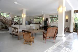 a living room with a couch and a table and chairs at Villa Varuna in Legian