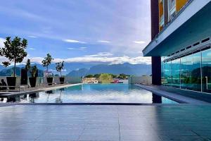 a swimming pool in a building with a view of mountains at Festival Walk homestay,13min to Tambun Lost World in Ipoh