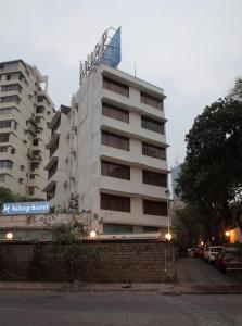 a tall building with a sign on top of it at Hiltop Hotel in Mumbai